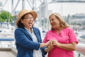 Caregiver and client laughing outside