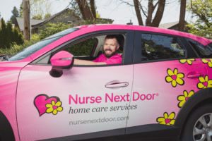 Caregiver driving a Nurse Next Door Pink Car