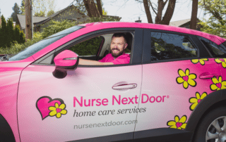 Caregiver driving a Nurse Next Door Pink Car