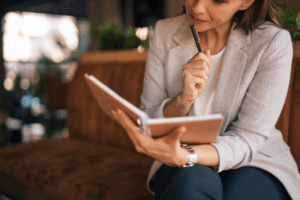 Woman thinking with notebook