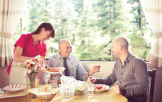 A smiling Nurse Next Door Caregiver with client and family.